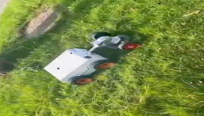 Top-down view of robot mower cutting grass