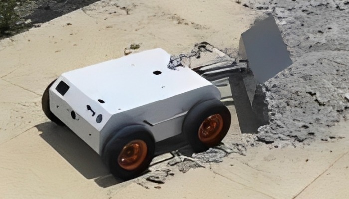Robot clearing wet concrete on pavement
