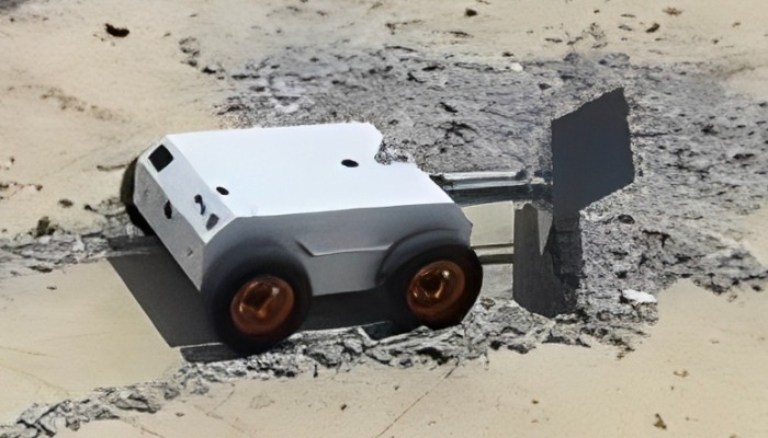 Top view of robot plow working in wet cement